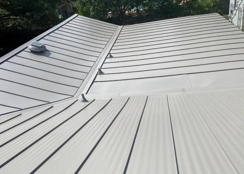 Solar attic fan installed on a metal roof for Roof Ventilation in Carlyss